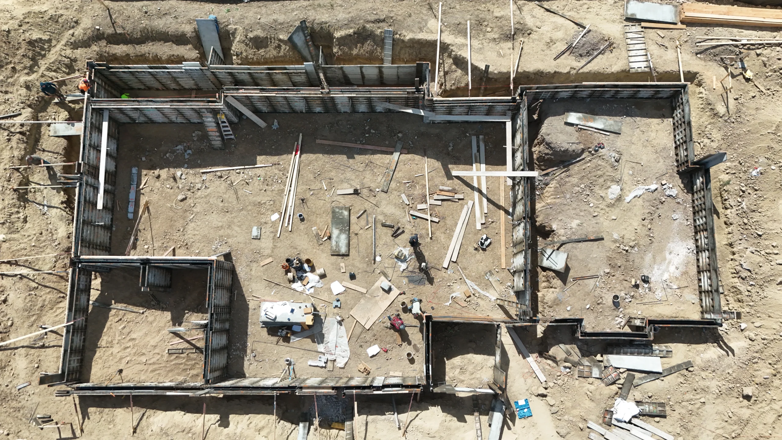 Aerial eagle-eye view of Fort August Construction concrete foundation framing project for custom home